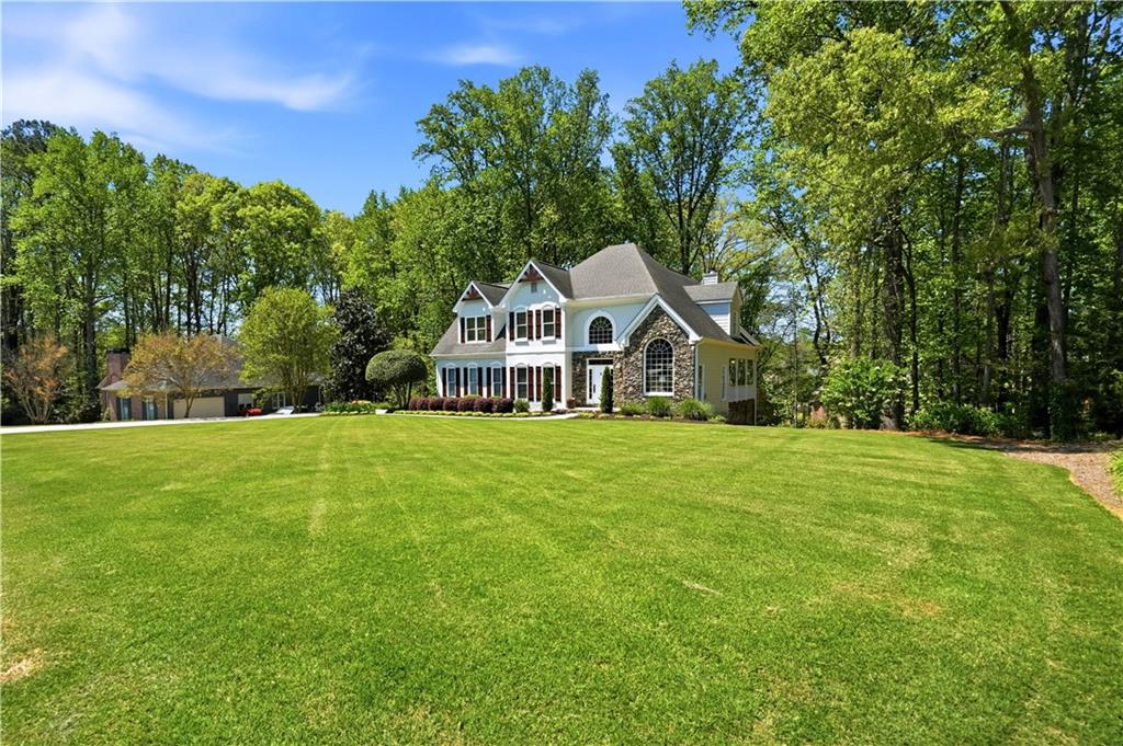 3660 Chartwell Drive Suwanee, GA 30024 - Photo 2 of 50 a front view of a house with a garden
