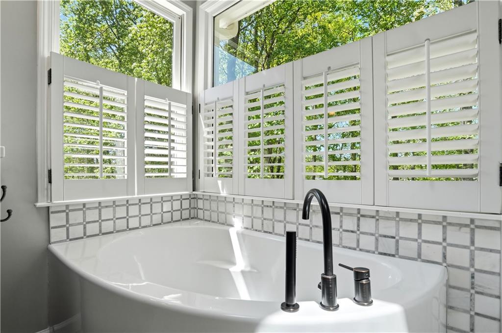 3660 Chartwell Drive Suwanee, GA 30024 - Photo 21 of 50 a bathroom with a bathtub and next to a window