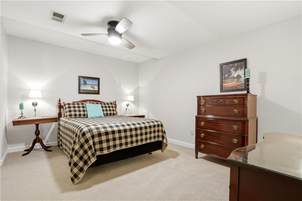 3660 Chartwell Drive Suwanee, GA 30024 - Photo 31 of 50 a bedroom with a bed and a cabinets