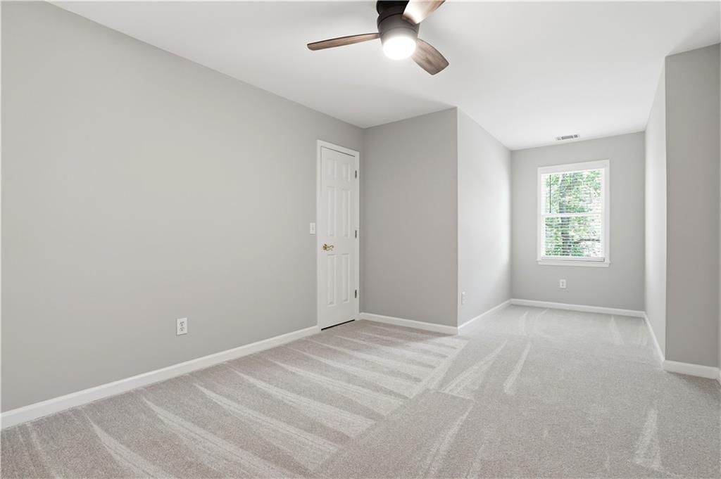 3660 Chartwell Drive Suwanee, GA 30024 - Photo 32 of 50 an empty room with a window and a fan