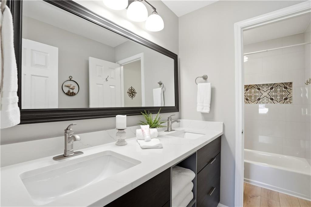 3660 Chartwell Drive Suwanee, GA 30024 - Photo 34 of 50 a bathroom with a sink and a mirror