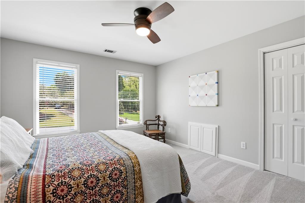 3660 Chartwell Drive Suwanee, GA 30024 - Photo 35 of 50 a bedroom with a bed and a large window