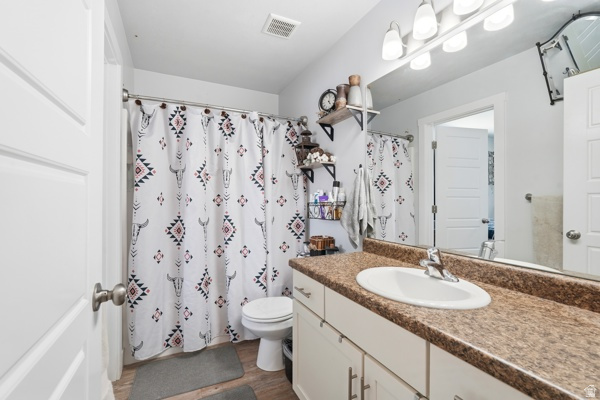 391 South 440th Street West Preston, ID 83263 - Photo 13 of 28 Full bathroom featuring a single vanity with an integrated sink, a large mirror, and overhead vanity lighting