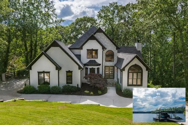 a front view of a house with yard and green space