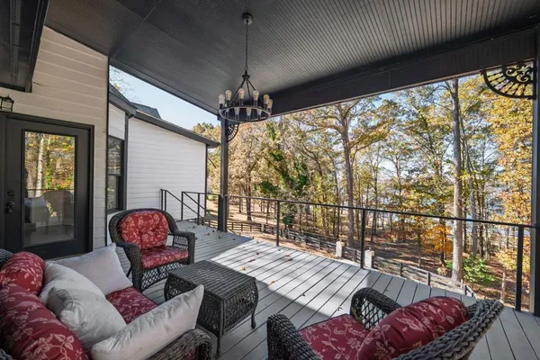 a spacious bedroom with a bed and a chandelier
