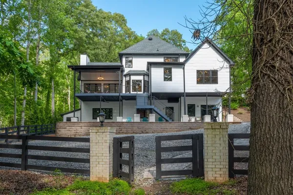 a backyard of a house with barbeque oven table and chairs