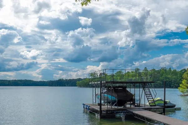 a view of a lake with a bench in the background