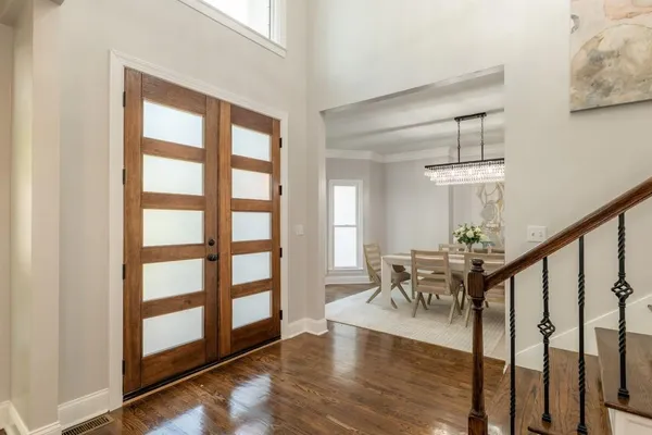 a view of a livingroom kitchen and dinning room with wooden floor