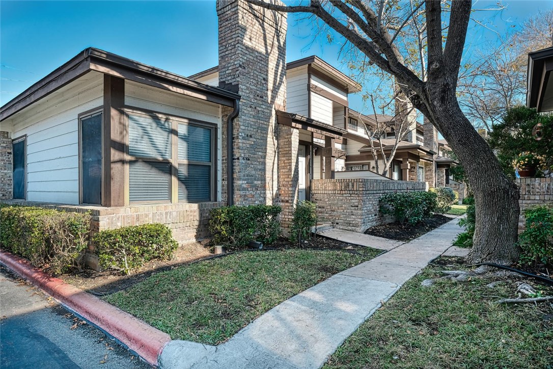 1748 Ohlen Road, Unit 74 Austin, TX 78757 - Photo 1 of 15 a front view of a house with garden