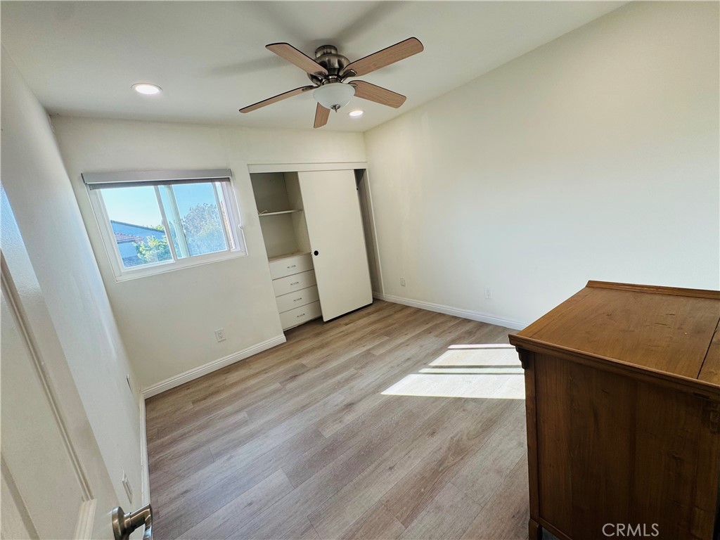 3 White Birch Irvine, CA 92604 - Photo 13 of 22 en empty room with wooden floor and fan