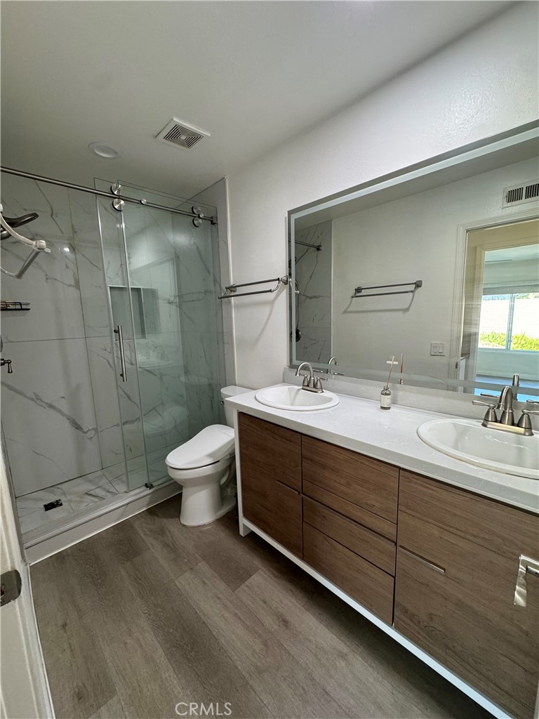 3 White Birch Irvine, CA 92604 - Photo 14 of 22 a bathroom with a double vanity sink toilet mirror and shower