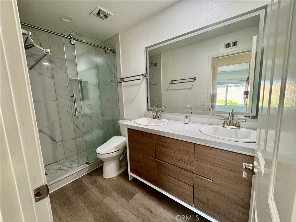 3 White Birch Irvine, CA 92604 - Photo 15 of 22 a bathroom with a double vanity sink toilet and shower