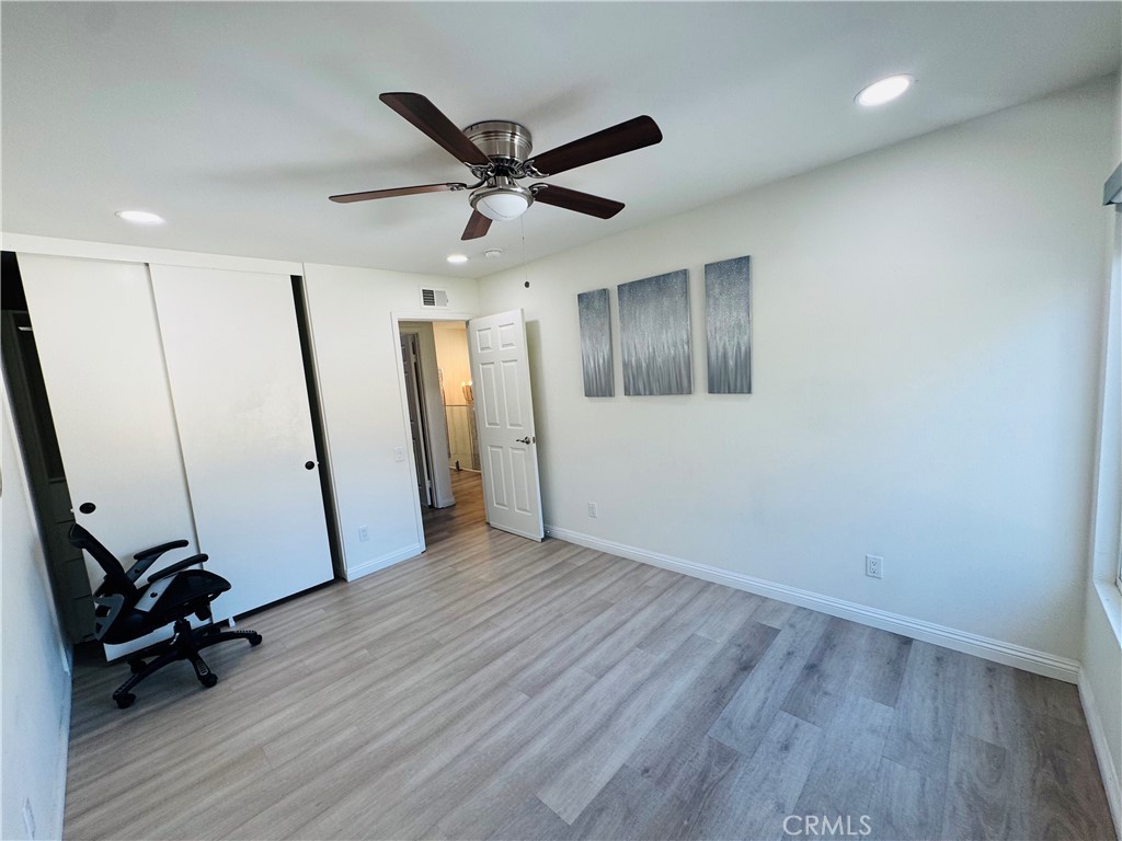 3 White Birch Irvine, CA 92604 - Photo 17 of 22 an empty room with wooden floor and windows