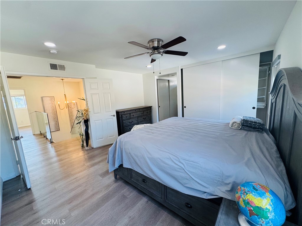 3 White Birch Irvine, CA 92604 - Photo 18 of 22 a spacious bedroom with a bed and a chandelier