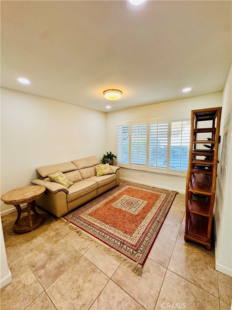 3 White Birch Irvine, CA 92604 - Photo 4 of 22 a living room with furniture a rug and gym equipment