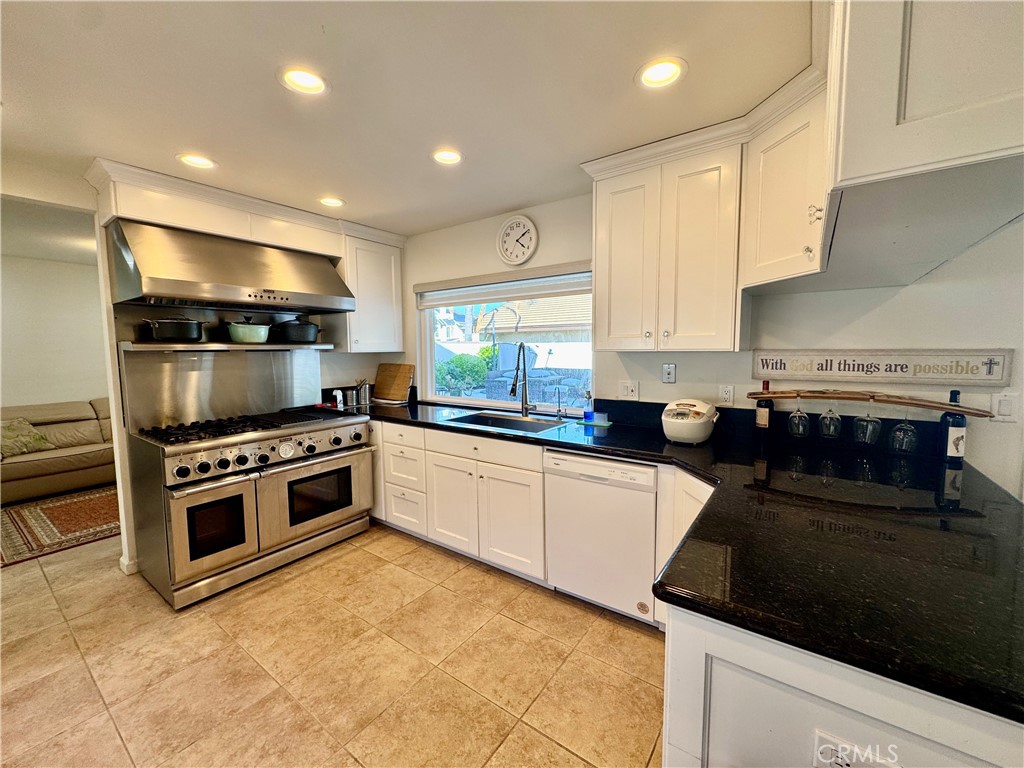 3 White Birch Irvine, CA 92604 - Photo 8 of 22 a kitchen with granite countertop a stove and a sink