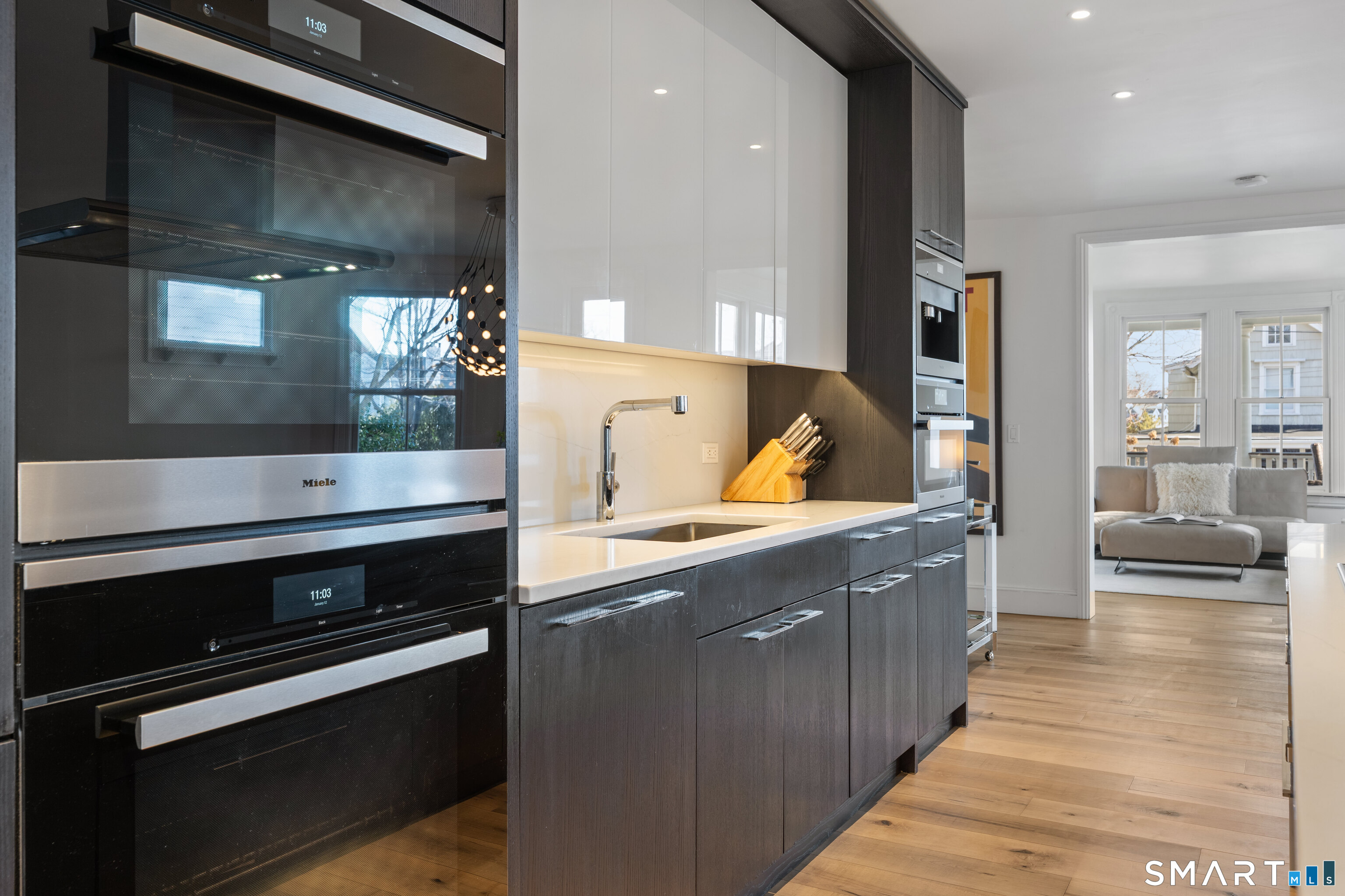22 Ensign Road Norwalk, CT 06853 - Photo 12 of 39 a kitchen with stainless steel appliances and wooden cabinets