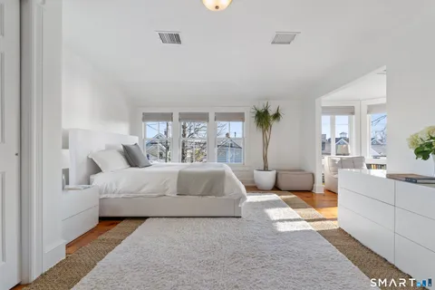 a living room with furniture a flat screen tv and a large window