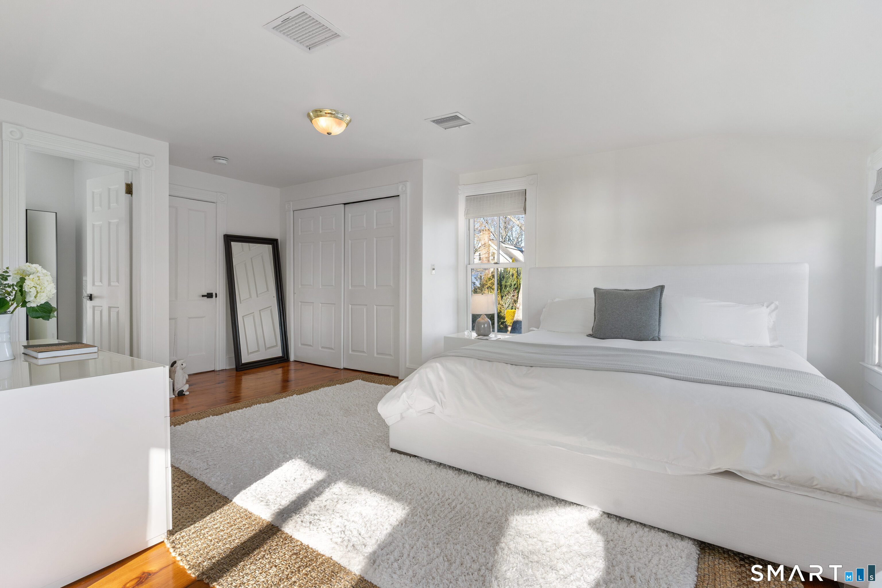 22 Ensign Road Norwalk, CT 06853 - Photo 20 of 39 a spacious bedroom with a bed and a couch