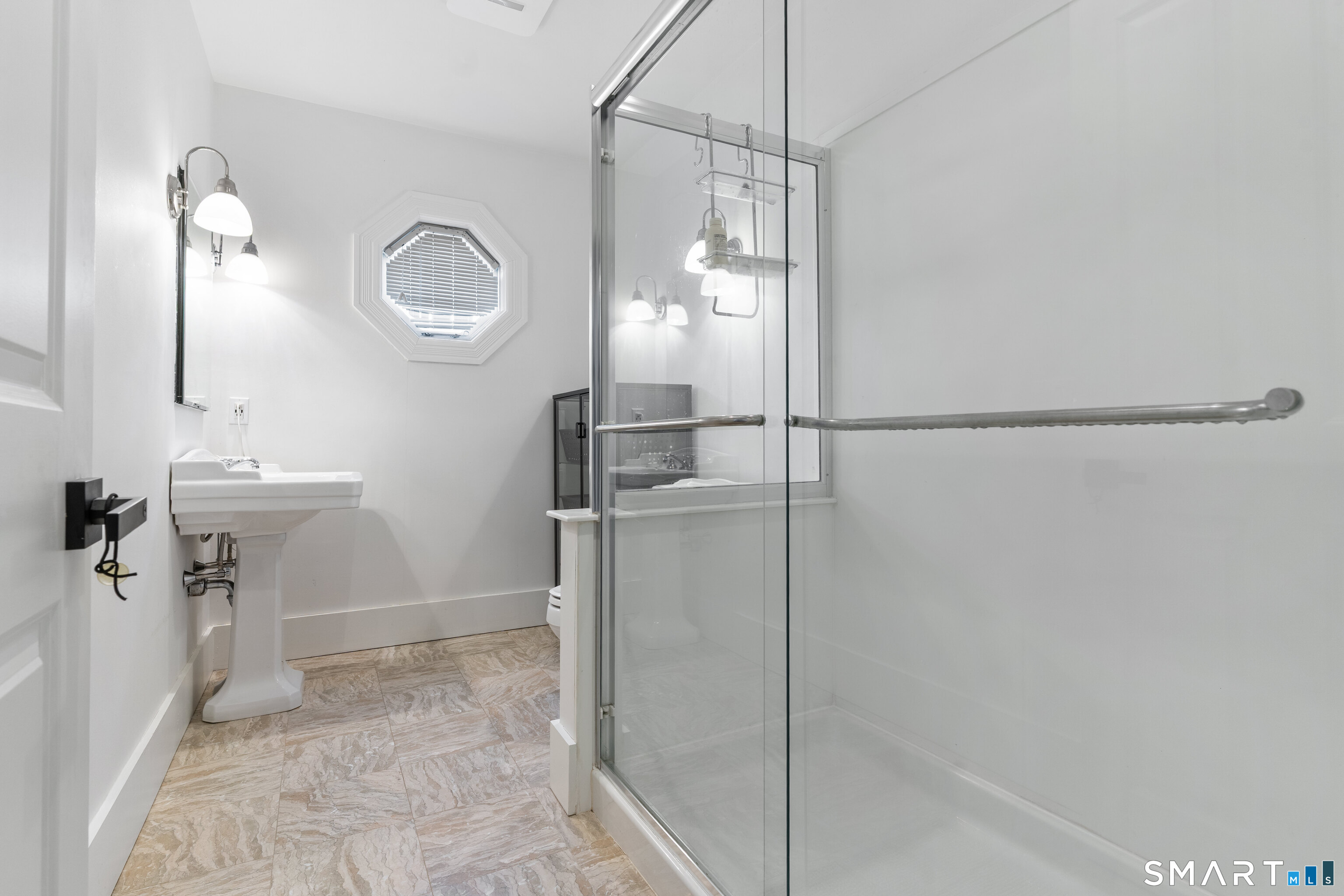 22 Ensign Road Norwalk, CT 06853 - Photo 25 of 39 a bathroom with a sink a mirror and shower