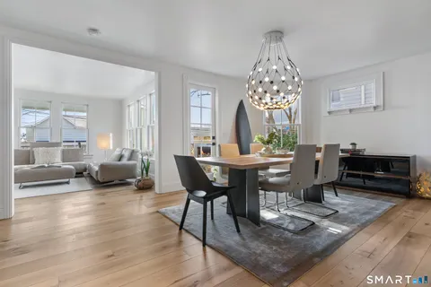 a living room with furniture kitchen and a table