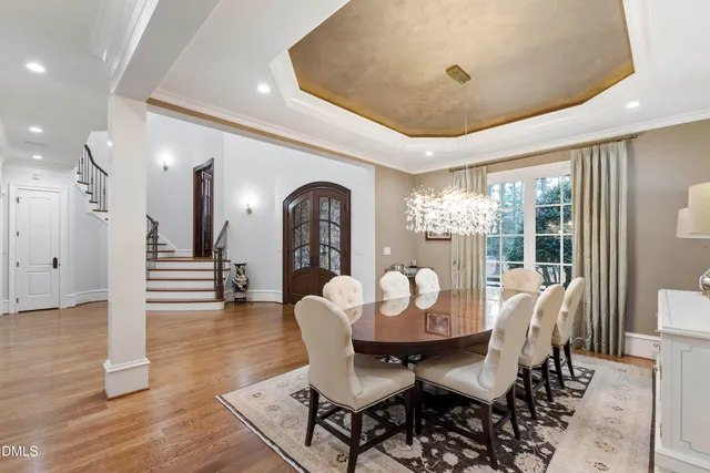 a dining room with furniture window and wooden floor