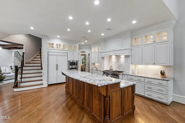 a living room with furniture and floor to ceiling windows