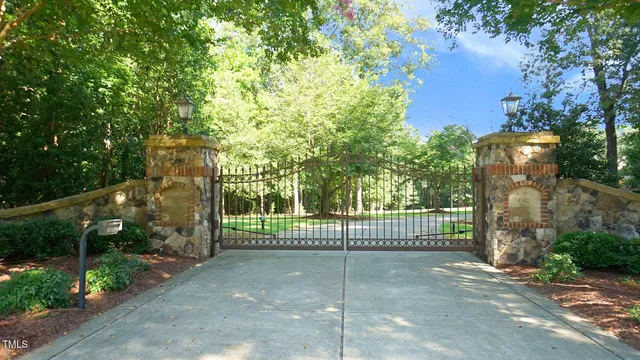 an aerial view of a house with table chairs and a fire pit