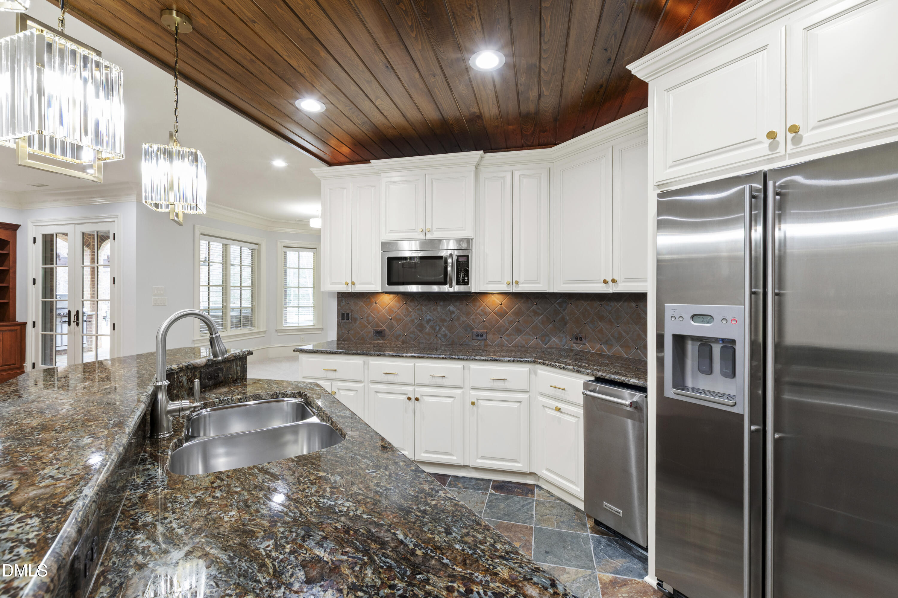 15508 Possum Track Road Raleigh, NC 27614 - Photo 64 of 85 a kitchen with stainless steel appliances granite countertop a sink a stove and a refrigerator