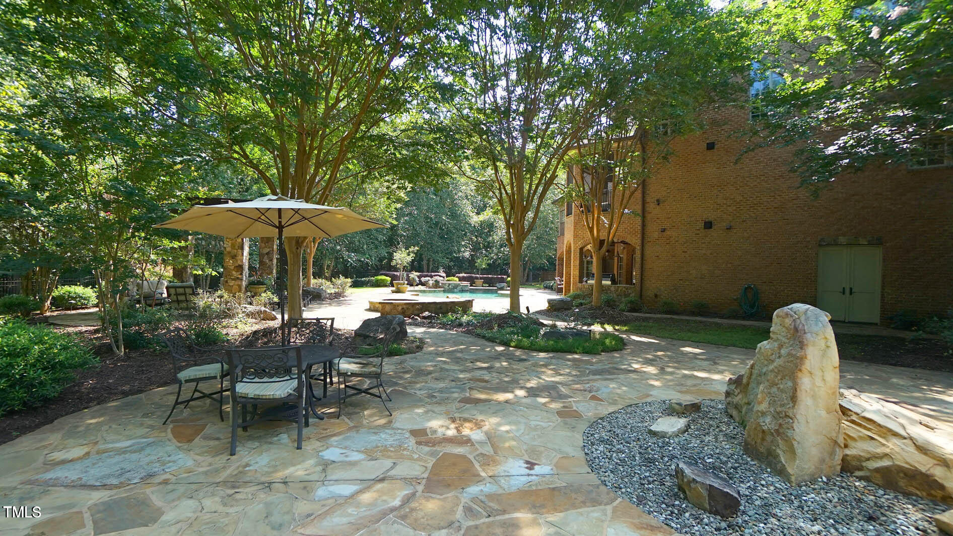 15508 Possum Track Road Raleigh, NC 27614 - Photo 10 of 85 a view of a tables and chairs under an umbrella