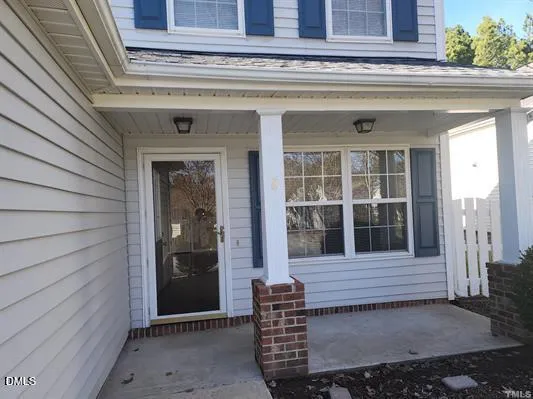 a view of a room with wooden floor and a window
