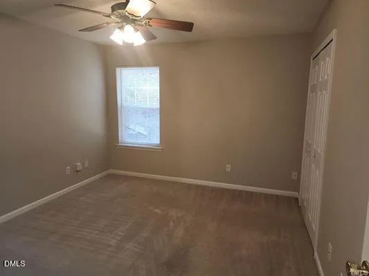 a bathroom with a shower curtain and a toilet