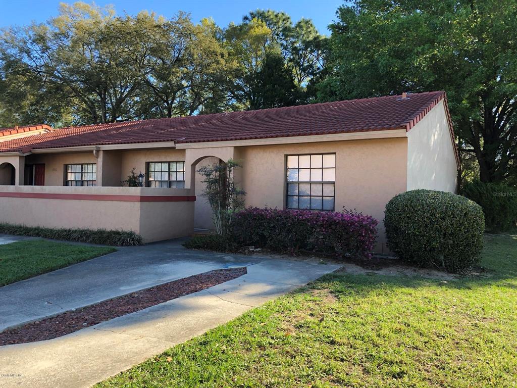 1939 Southwest 34th Court Ocala, FL 34474 - Photo 1 of 1 a backyard of a house with barbeque oven and outdoor seating