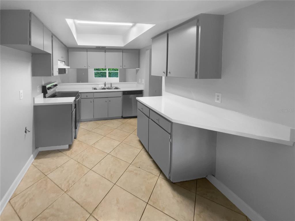 2131 Ridge Road South, Unit 80 Largo, FL 33778 - Photo 12 of 27 a kitchen with a sink window and cabinets