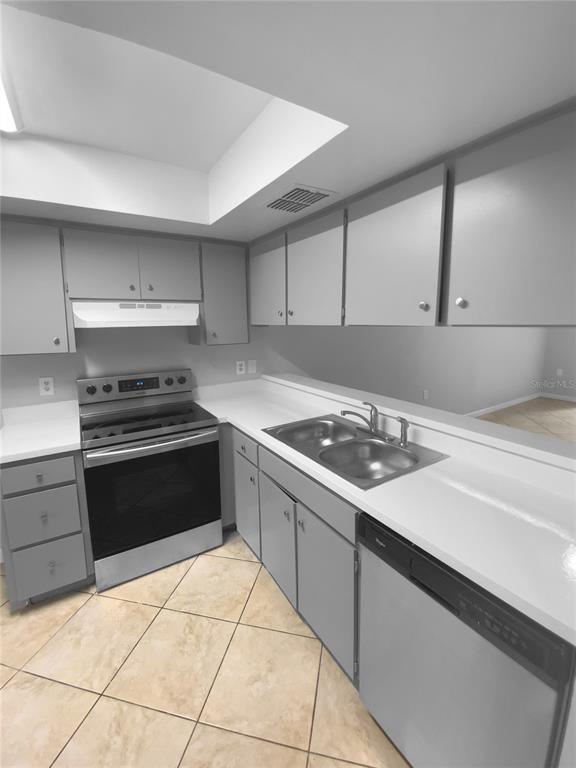 2131 Ridge Road South, Unit 80 Largo, FL 33778 - Photo 13 of 27 a kitchen with a sink and white stainless steel appliances