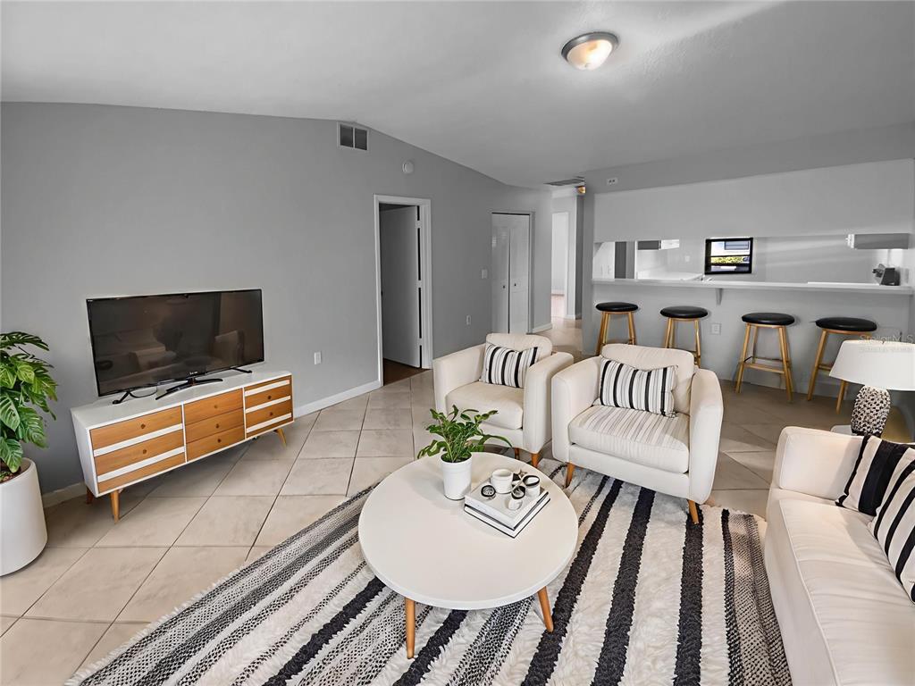 2131 Ridge Road South, Unit 80 Largo, FL 33778 - Photo 2 of 27 a living room with furniture and a flat screen tv