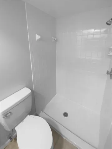 a bathroom with a toilet and a shower