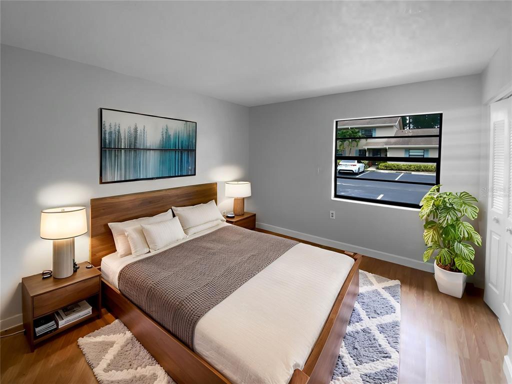 2131 Ridge Road South, Unit 80 Largo, FL 33778 - Photo 4 of 27 a bedroom with a bed and a painting on the wall