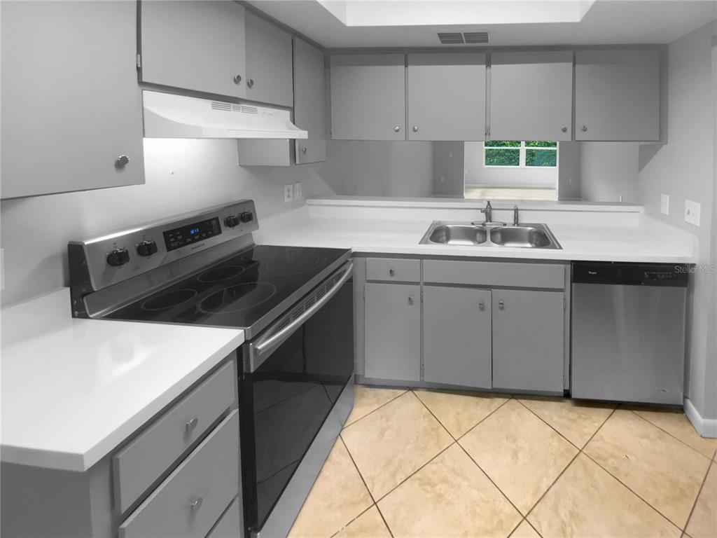 2131 Ridge Road South, Unit 80 Largo, FL 33778 - Photo 6 of 27 a kitchen with a sink cabinets and appliances