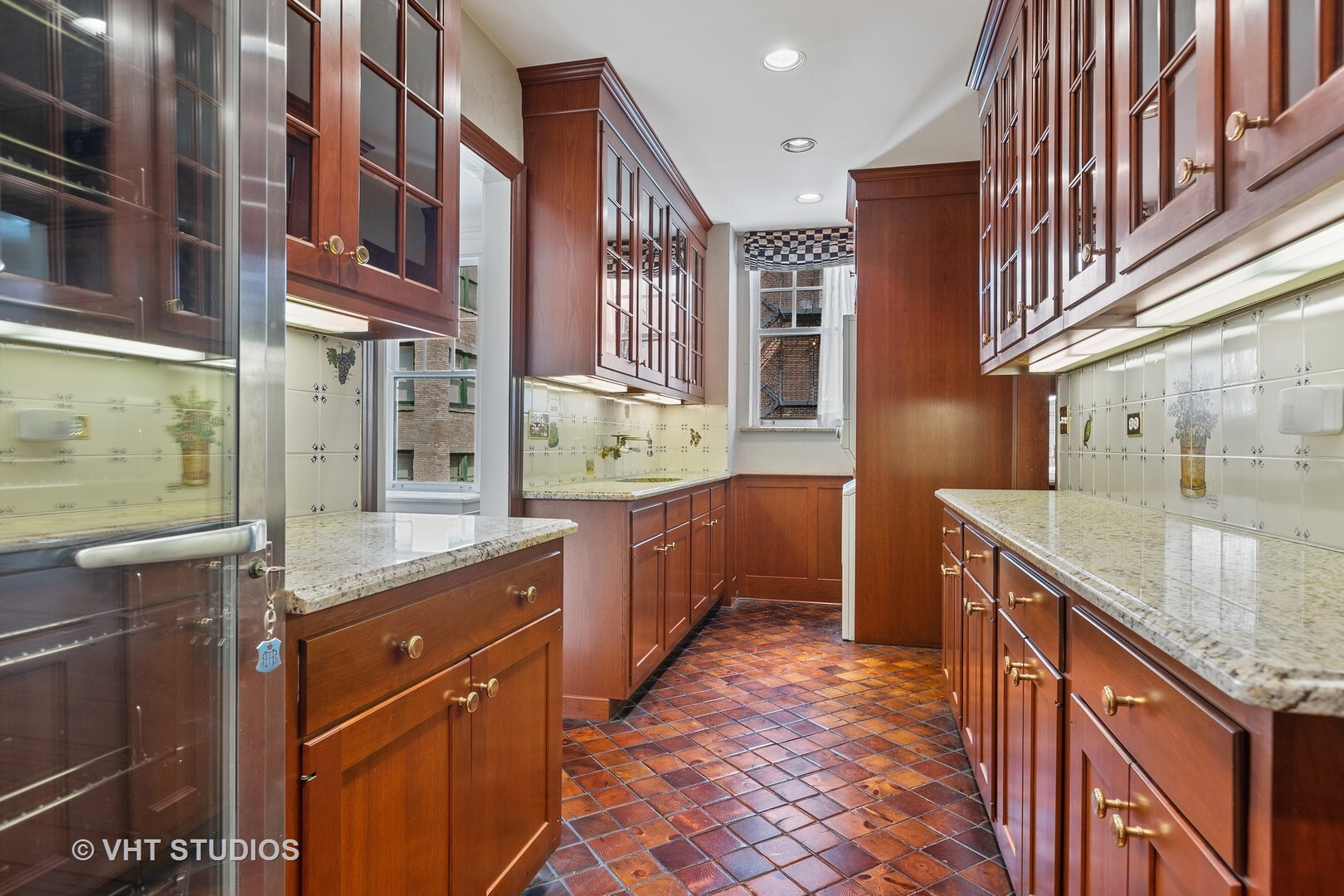 220 East Walton Place, Unit 9W Chicago, IL 60611 - Photo 6 of 19 a kitchen with stainless steel appliances granite countertop a sink and a stove