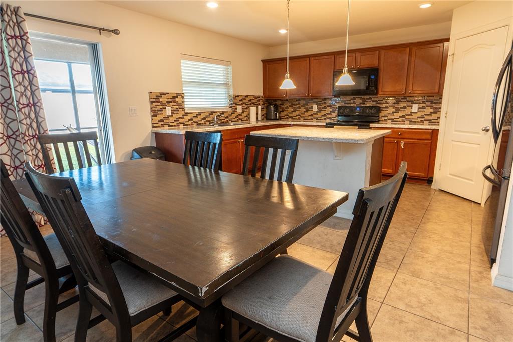 4563 Orchard Grove Road St. Cloud, FL 34772 - Photo 37 of 51 a view of a dining room with furniture