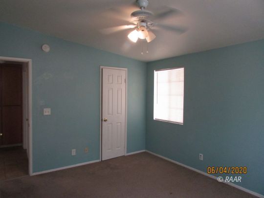 304 North Florence Street Ridgecrest, CA 93555 - Photo 7 of 21 an empty room with windows and fan