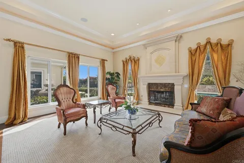 a spacious bedroom with a bed a flat screen tv and a large window with outer view