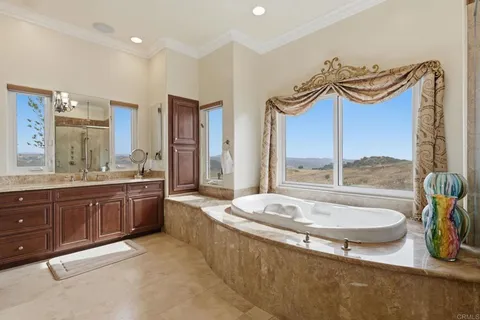 a bathroom with a sink a toilet a mirror and shower