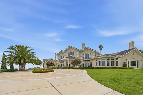 a living room with a large window and a wooden floor