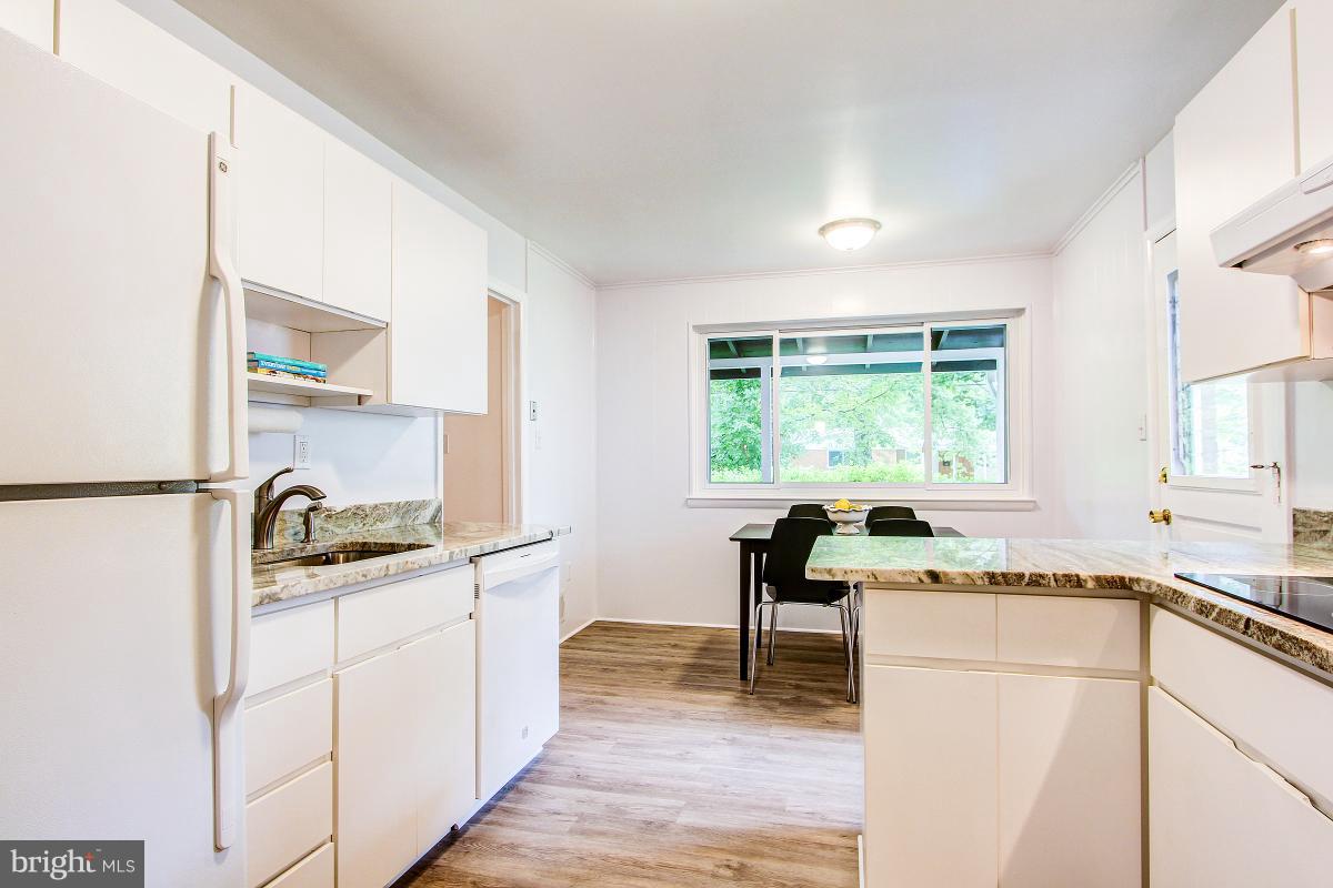 10822 Margate Road Silver Spring, MD 20901 - Photo 11 of 29 a kitchen with granite countertop a stove a sink and a refrigerator