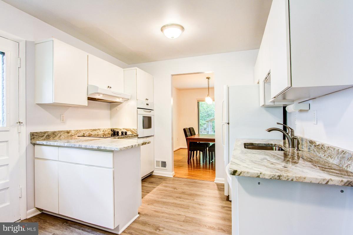 10822 Margate Road Silver Spring, MD 20901 - Photo 13 of 29 a kitchen with granite countertop a sink stove and cabinets