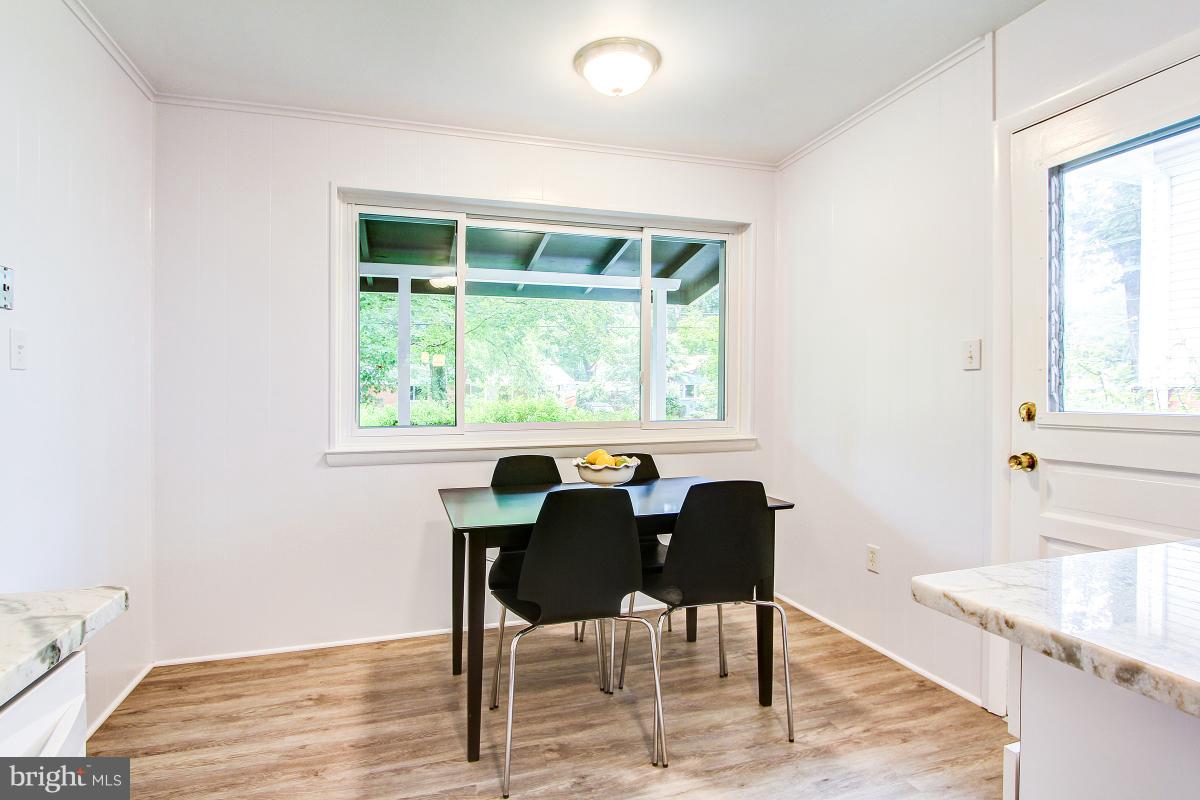 10822 Margate Road Silver Spring, MD 20901 - Photo 15 of 29 a view of a dining room with furniture and wooden floor