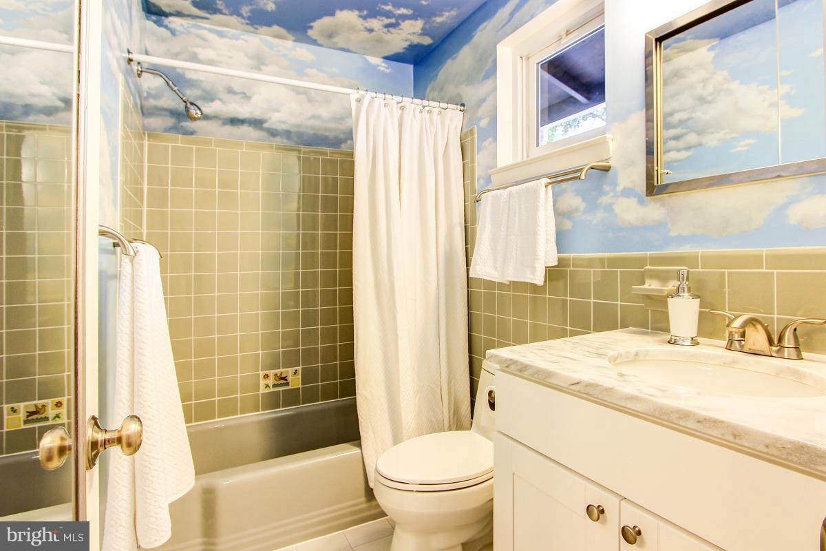 10822 Margate Road Silver Spring, MD 20901 - Photo 20 of 29 a bathroom with a sink toilet vanity and shower