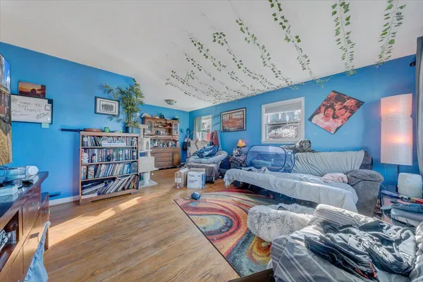 a living room with furniture and wooden floor